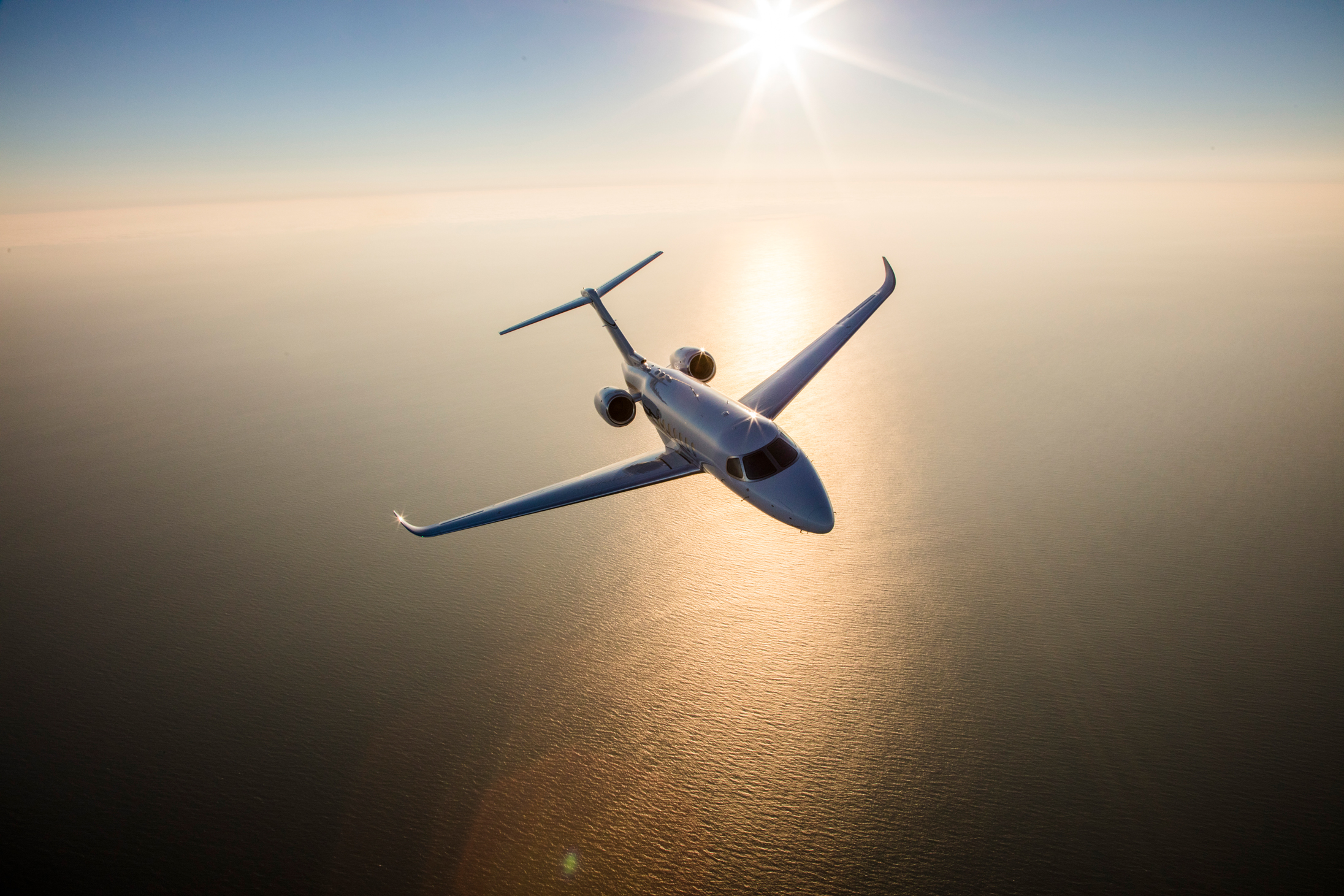 Gulfstream G200 Flying Above a River at Sunset